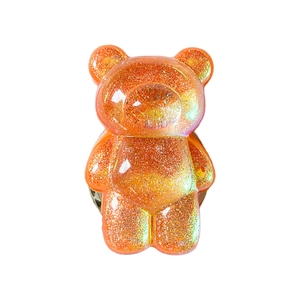 Translucent orange bear phone grip with sparkling glitter and retractable stand