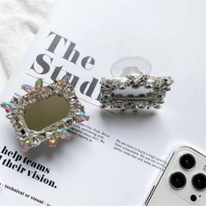 Luxe crystal phone sockets with mirror and rhinestone details on a magazine background