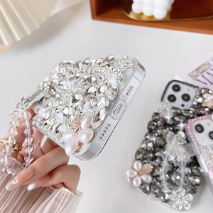Detailed view of luxury iPhone case with crystals, pearls and beaded wrist strap