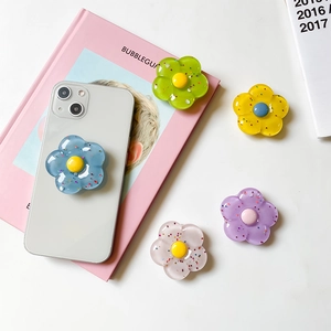 Dettaglio di supporti per telefono a forma di fiore in resina glitterata e adesiva