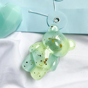 Mint green bear phone grip with gold foil sequins and retractable airbag stand