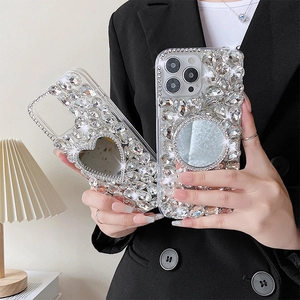 Close-up of luxury iPhone case with rhinestone heart mirror and glittering crystals