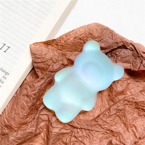 Iridescent blue bear cell phone grip stand with matte finish on aesthetic background