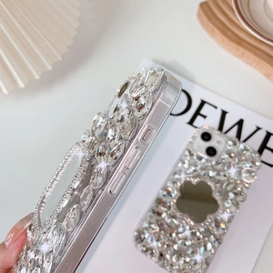 Close-up of luxury rhinestone iPhone case with floral mirror and sparkling crystal details