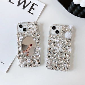 Detail of luxury iPhone case with makeup mirror, rhinestones, pearl flowers and bear motif
