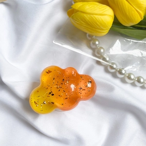 Cloud-shaped phone grip with orange gradient resin and gold foil glitter flakes