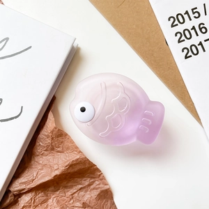 Detail view of a cute 3D fish phone grip with a purple gradient matte texture