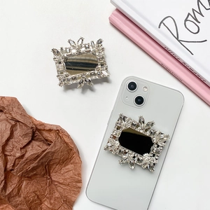 Close-up of luxury rhinestone square mirror phone socket with sparkling crystals