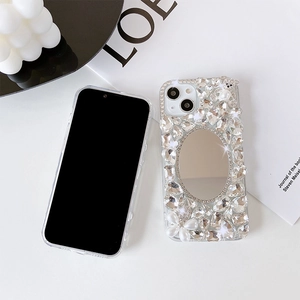 Detailed view of luxury iPhone case with embedded makeup mirror, pearls, and crystals