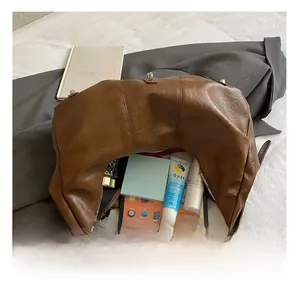 Detail showing the large interior capacity and zipper of this brown PU leather hobo bag