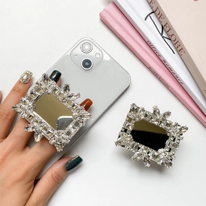 Macro detail of luxury rhinestone mirror phone grip on light colored smartphone