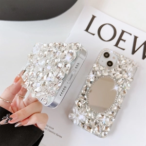 Detail of luxury iPhone case with crystals, vanity mirror and decorative 3D rabbit bow