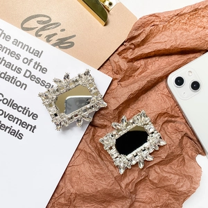 Macro detail of luxury rhinestone square phone mirror grip with sparkling crystal inlay