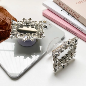 Macro detail of luxury silver rhinestone square foldable phone grip with integrated mirror