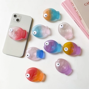 3D cute cartoon fish phone grip socket in various gradient colors on white surface