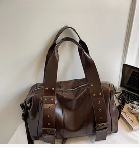 Close-up of vintage brown tote bag with retro rivets and metallic eyelet hardware detail