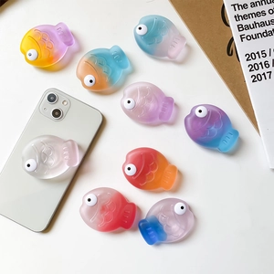 3D fish-shaped gradient phone grip stand with translucent matte finish on white smartphone