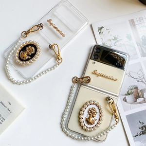 Detail of luxury Samsung Z Flip case with Sagittarius metal decor and pearl chain strap