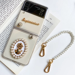 Detail of Galaxy Z Flip case with pearl strap and vintage Sagittarius relief on a book