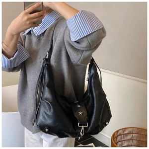 Mirror selfie showing the large black hobo bag with silver star studs on soft leather