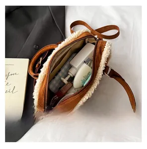 Interior view of brown suede crossbody bag with fleece trim showing ample storage space