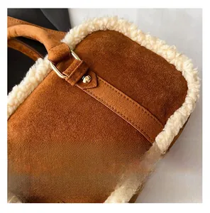 Detailed macro view of brown suede texture with faux fur trim and gold metal buckle