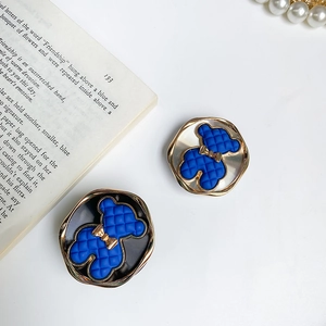 Detail of blue electroplated bear phone socket with quilted texture and gold bow