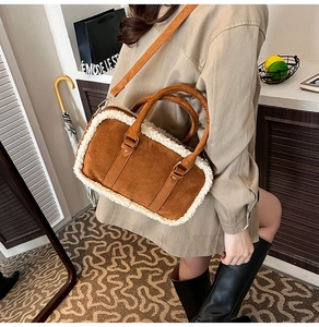 Detail of a brown suede bag with plush white faux fur trim and adjustable shoulder strap