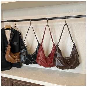 Detailed close-up of retro PU leather crescent bags featuring star rivet decorations