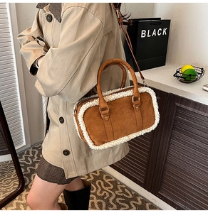 Brown suede shoulder bag with white faux shearling trim on a model in a beige coat
