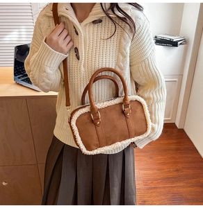 Detailed shot of brown suede crossbody bag featuring white faux shearling trim accents
