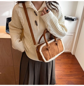 Close-up of brown suede cylinder pillow bag with white faux fur trim and shoulder strap