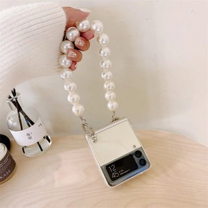 Detail of white foldable phone case with large pearl strap for Samsung Galaxy Z Flip
