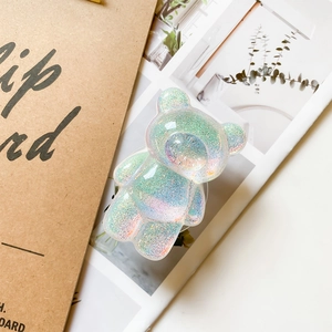 Bear-shaped glitter phone grip with iridescent finish and collapsible socket design