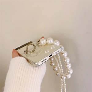Detail of Galaxy Z Flip case featuring a glossy pearl strap and crossbody chain link