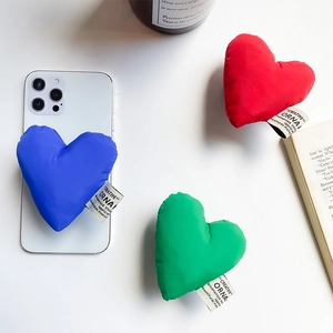 Close-up of colorful heart-shaped fabric phone grips with creative woven label
