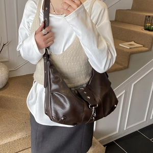 Vintage dark brown half-moon crossbody bag with silver star rivets and soft leather finish