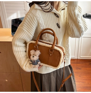 Detail of brown suede crossbody bag with white faux shearling trim and plush bear charm