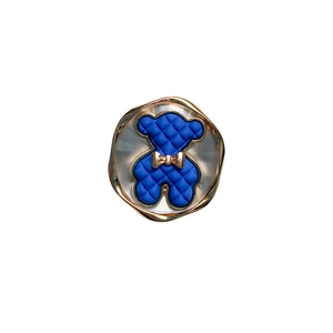 Minimalist blue bear phone grip with gold bow and elegant metallic wave edge