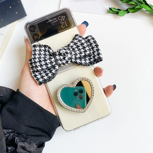 Detail of Galaxy Z Flip case with houndstooth bow and rhinestone heart-shaped mirror