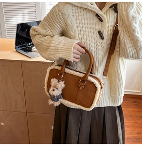 Brown faux suede crossbody bag with plush white trim and a cute teddy bear charm