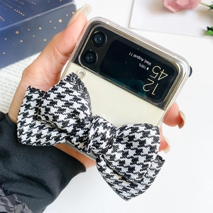Detail of transparent Galaxy Z Flip case with a large houndstooth bow and gift box decor