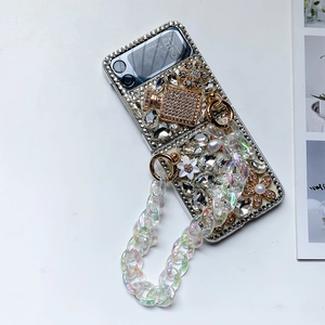 Detail of luxury rhinestone phone case for Z Flip with pearl chain and perfume bottle deco