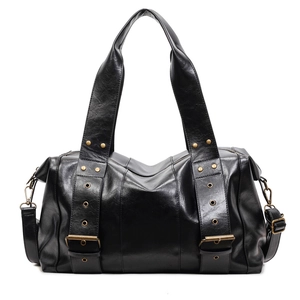 Classic black faux leather tote bag with vintage bronze hardware and crossbody strap