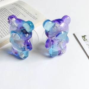 Detail showing gradient blue-purple bear pop socket with 3D cloud effect texture