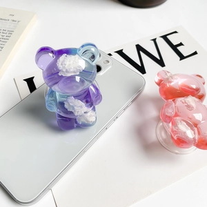Detail of pink and purple cloud bear phone sockets on a white smartphone back