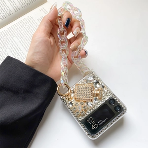 Luxurious Z Flip case with sparkling crystals, golden charms and acrylic pearl hand chain