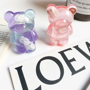 Macro view of semi-transparent resin bear phone grips with blue and pink cloud patterns