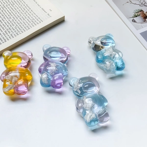 Detail of cloud-filled bear phone grip with transparent resin finish and pastel gradients