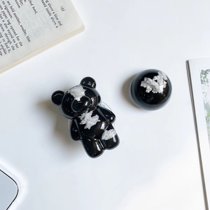 Detail of glossy black bear and circular phone grip with artistic white cloud graffiti